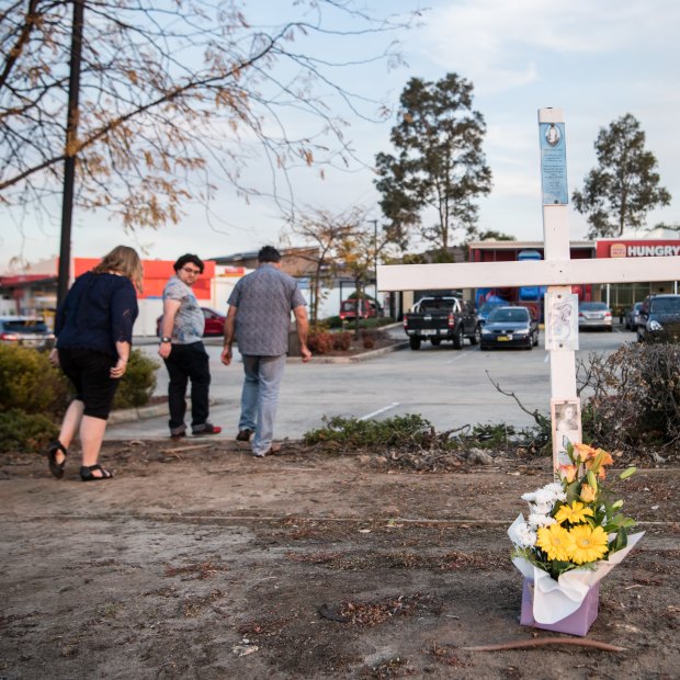 A cross outside the Hungry Jack’s car park in southwest Sydney marks the spot where police shot Courtney Topic.