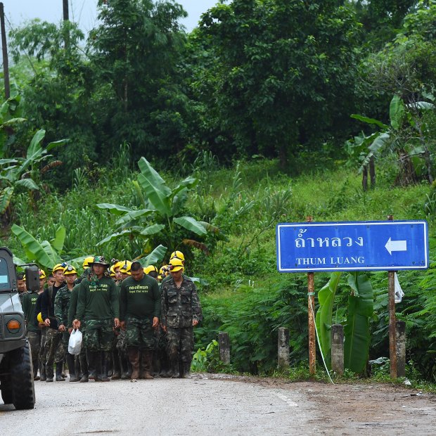 Thai army soldiers return from the base camp near Tham Luang cave.