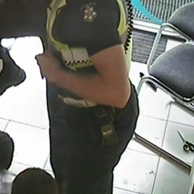 A still from CCTV footage of the arrest of a man in a Preston chemist.