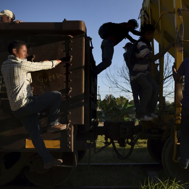 Young men ride La Bestia (“The Beast”) – the freight train that heads north from Guatemala, through Mexico and on to the US border – at the Mexican town of Tenosique.