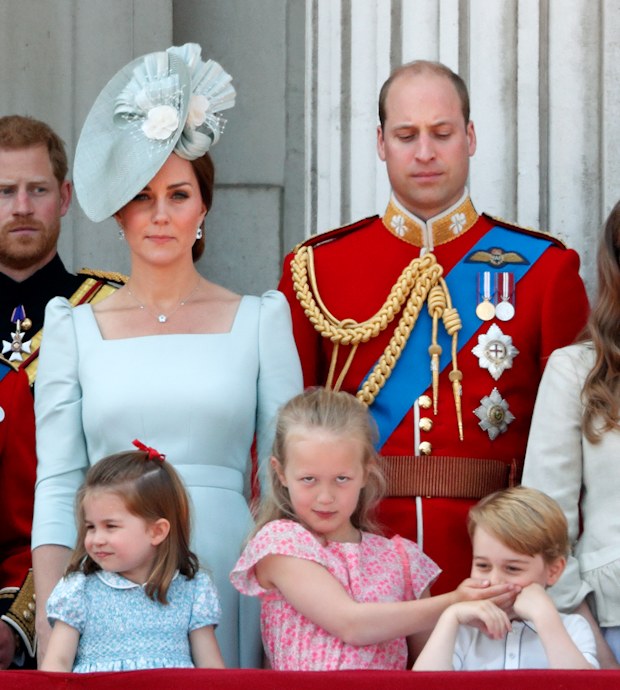 Catherine, Duchess of Cambridge, Princess Charlotte, Prince William and Savannah Phillips (with her hand over Prince George's mouth) stand on the balcony of Buckingham Palace during Trooping The Colour 2018 on June 9, 2018 in London, England.