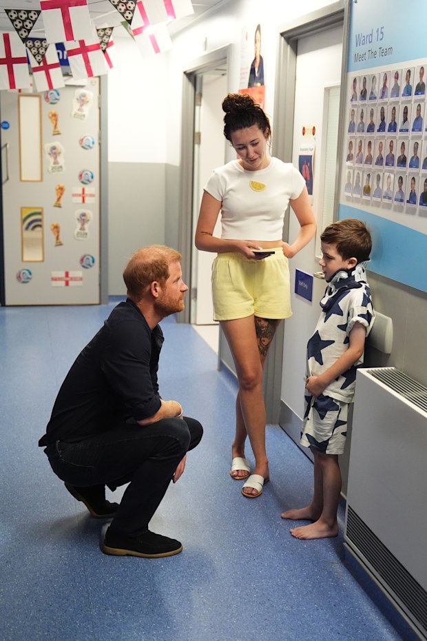Prince Harry, Duke of Sussex, Patron of WellChild, meets patient Alfie Hodges, seven, and his mother Mia Drysdale, during a visit to the Birmingham Children’s Hospital