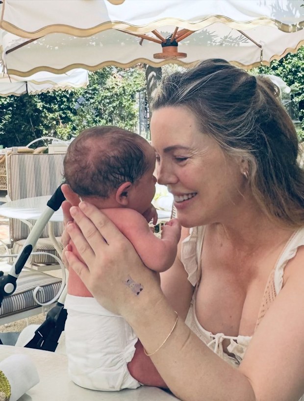 Melissa George with her fourth son and newborn