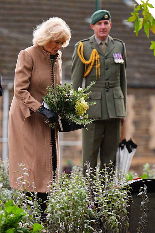 Queen Camilla lays flowers at Aberfan Memorial Garden, during a commemoration event to mark the 60th anniversary of the Aberfan disaster