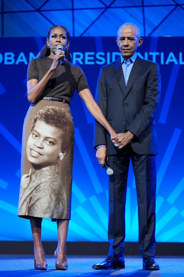 Former President Barack Obama stands on stage with former first lady Michelle Obama at a stakeholders event at the Obama Presidential Centre