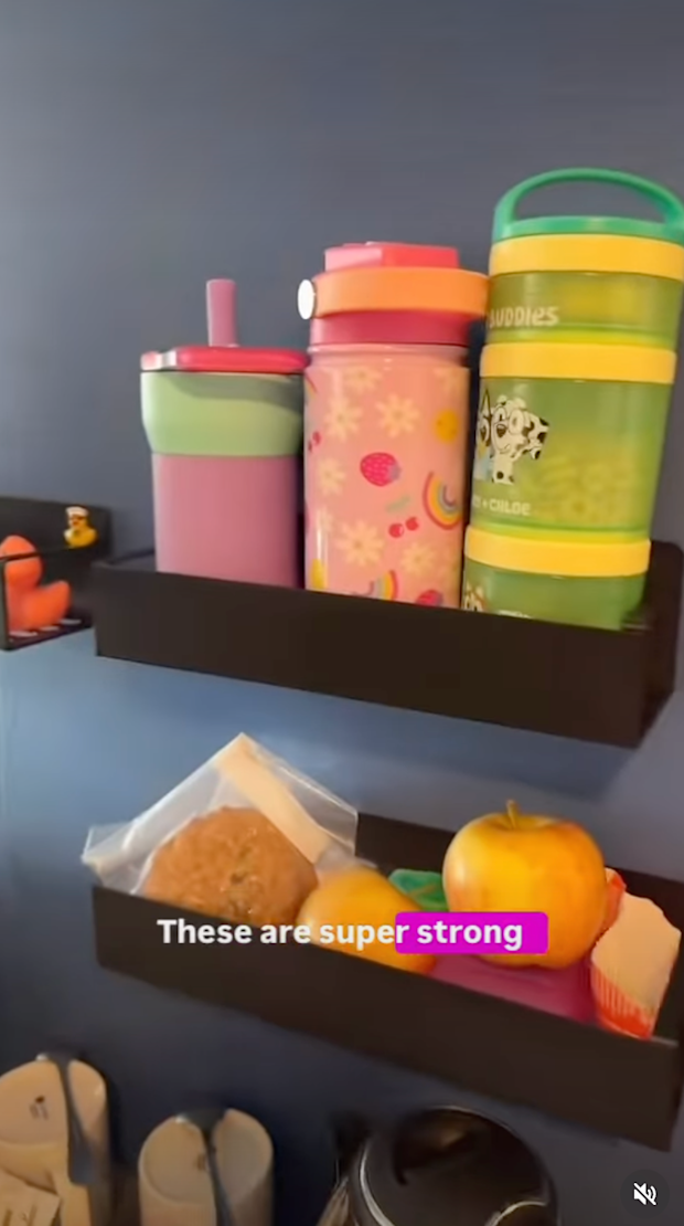 A shelf of water bottles and snacks
