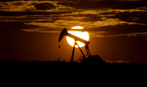 The sun sets behind an idle pump jack near Karnes City, Texas. Demand for oil continues to fall due to the coronavirus outbreak.