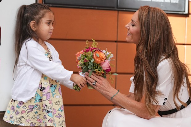 Catherine, Princess of Wales, receives flowers from 5 years old Amelie after her visit to Evelina London Children’s Hospital