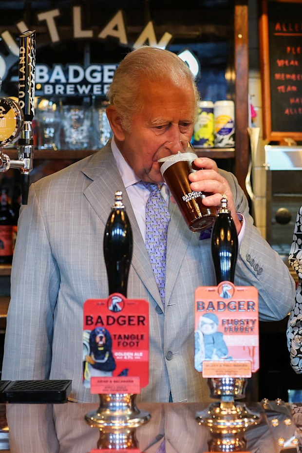 King Charles III drinks a pint in the Hall and Woodhouse Badger Brewery bar as the brewery celebrates its 250th anniversary on July 16, 2026 in Blandford Forum, England