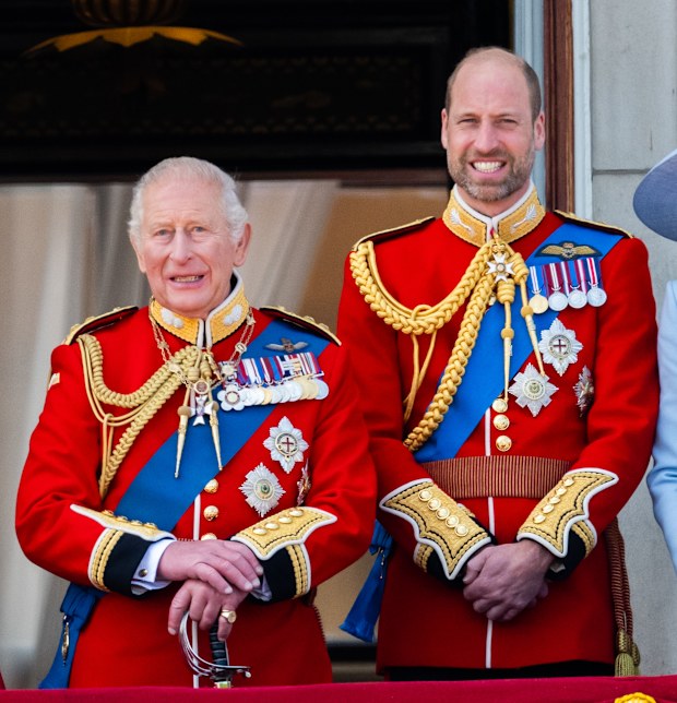 King Charles III and Prince William, Prince of Wales watch an RAF flypast from the balcony of Buckingham Palace during Trooping The Colour on June 13, 2026