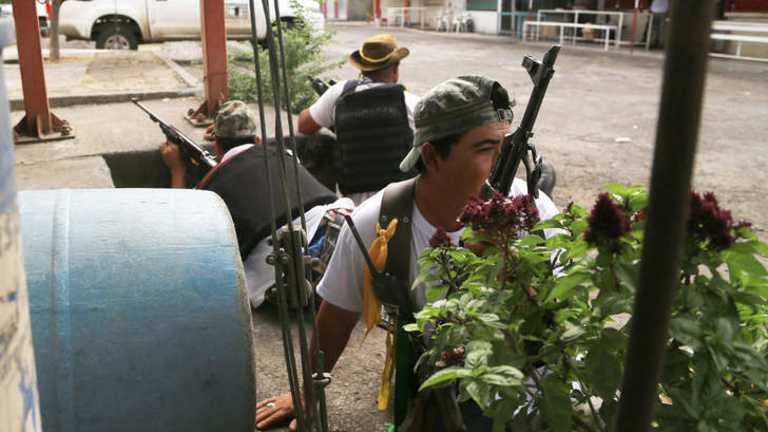 Vigilante groups occupy another Mexican city