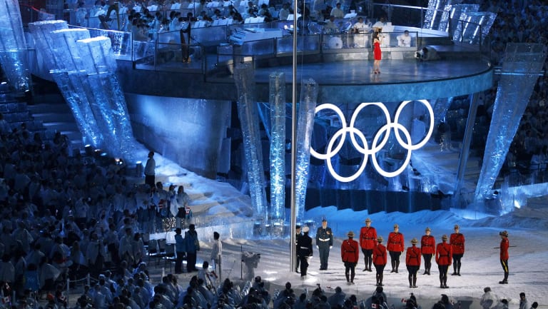 Members of the Royal Canadian Mounted Police and armed forces raise the flag as the national anthem is played at the opening ceremony of the 2010 Winter Olympics in Vancouver.