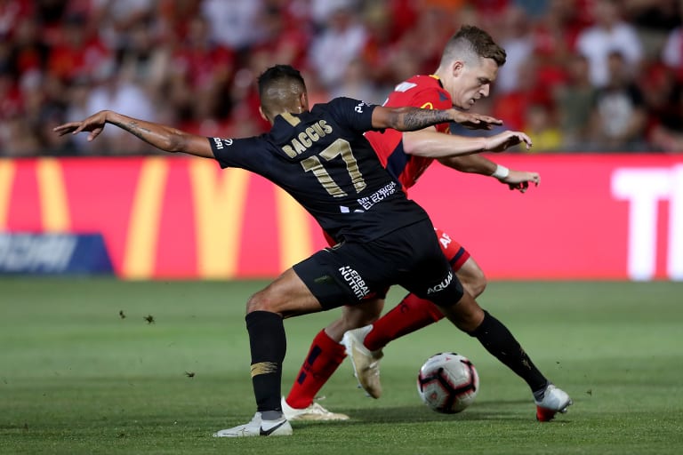 Battle: Keanu Baccus of the Wanderers tackles Scott Galloway.