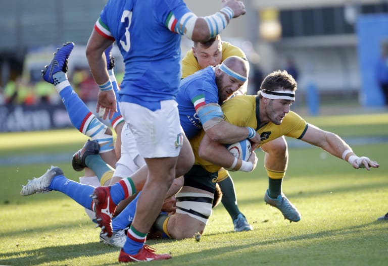 Izack Rodda, right, is tackled by Italy's Leonardo Ghiraldini.