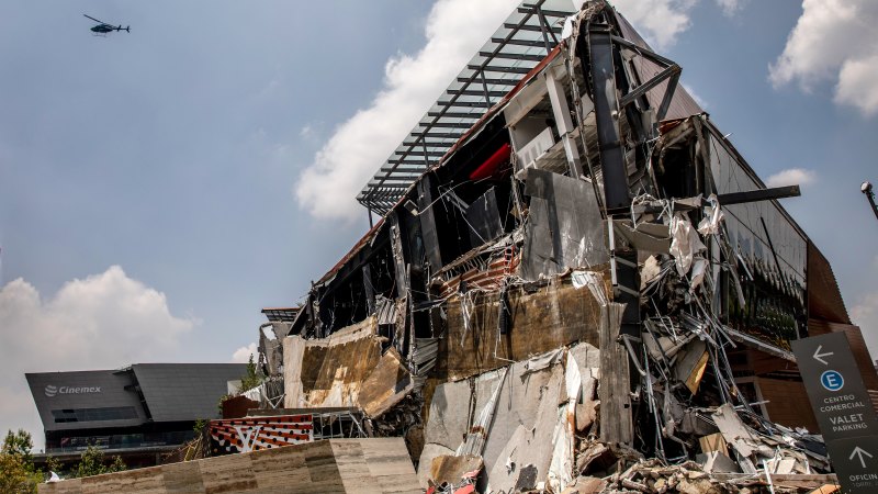 Fallen sections of the Artz Pedregal shopping mall lie on the