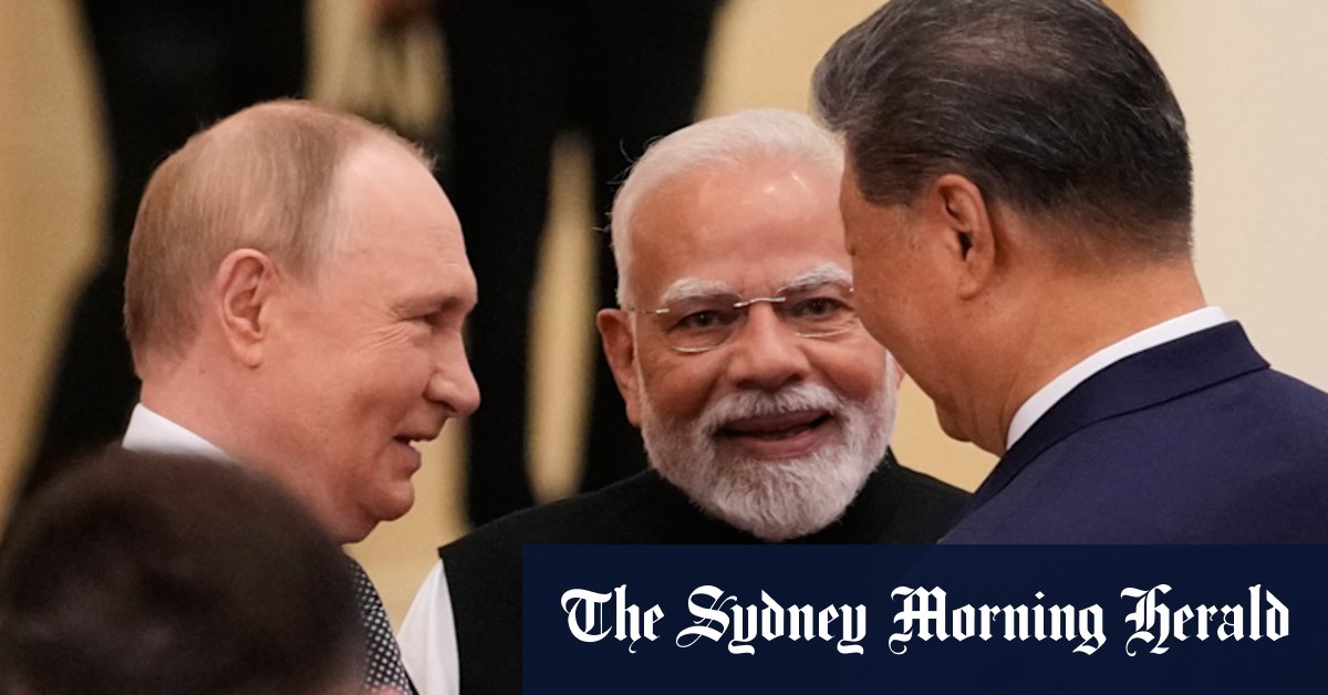 Smiles and clasped hands as Xi, Putin and Modi try to signal unity