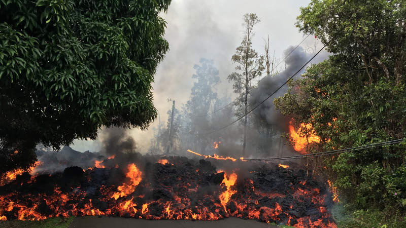 Hawaii officials airlift four residents after lava crosses road
