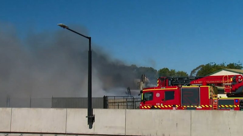 Crews fight Adelaide warehouse fire endangering homes