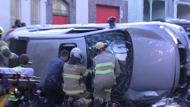 Police shove man to the ground moments after car flips