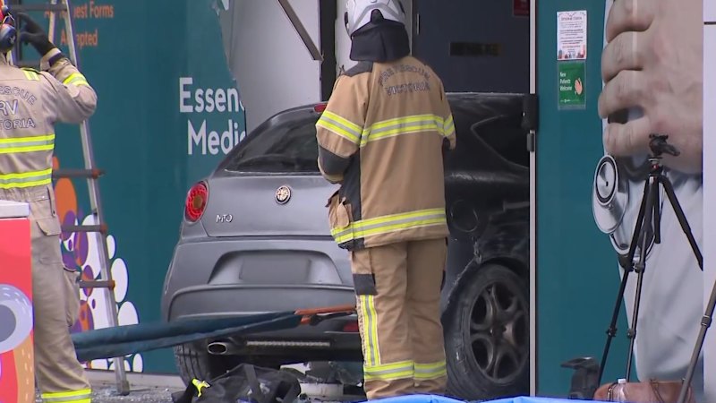 Man killed, woman injured after car smashes 30m into medical centre