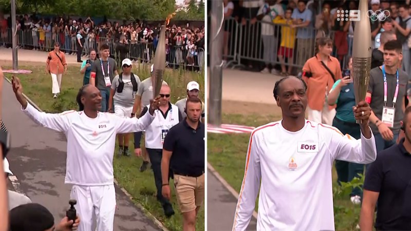 Snoop Dogg carries the Olympic torch before opening ceremony in Paris