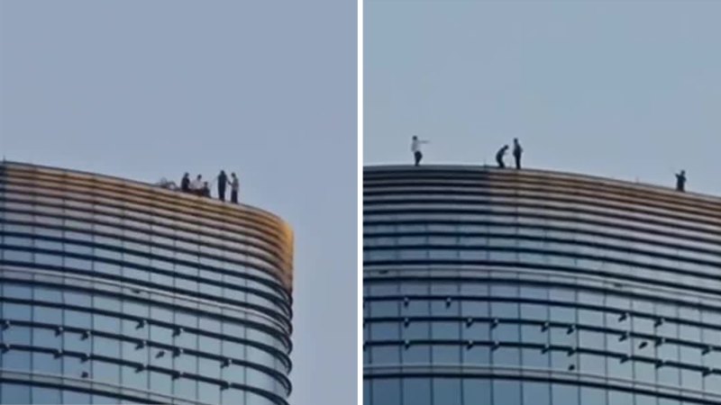 Daredevils caught on edge of Melbourne CBD skyscraper