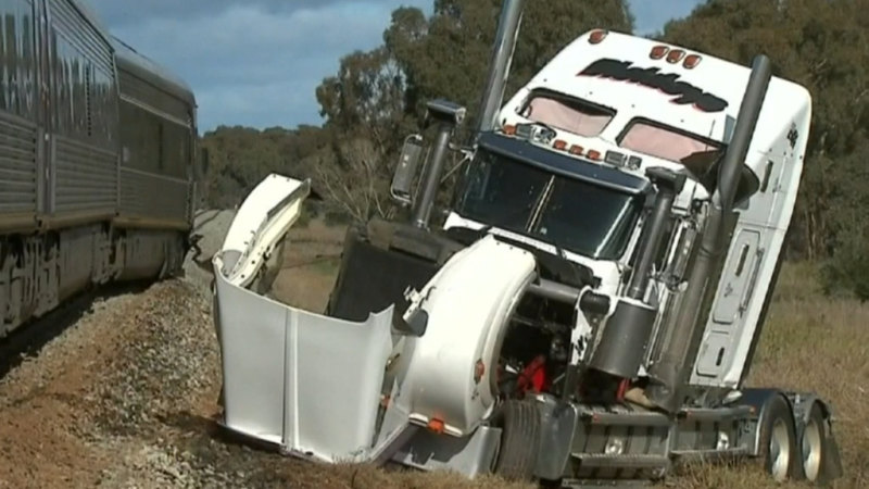Two people injured after truck and train collide in central Victoria