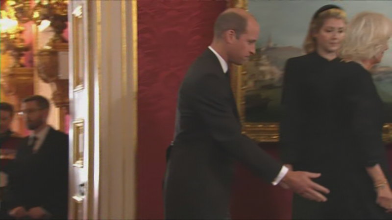 Prince William pats Queen Camilla on the back reassuringly