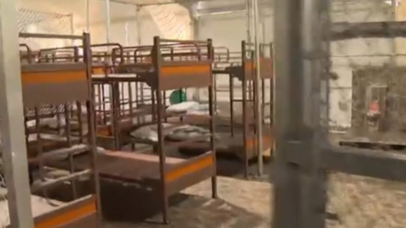 ‘Alligator Alcatraz’ put detainees in metal cages labeled ‘calming areas’