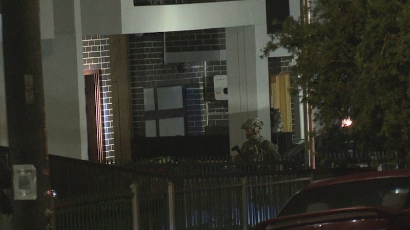 Tactical police surround home in Sydney
