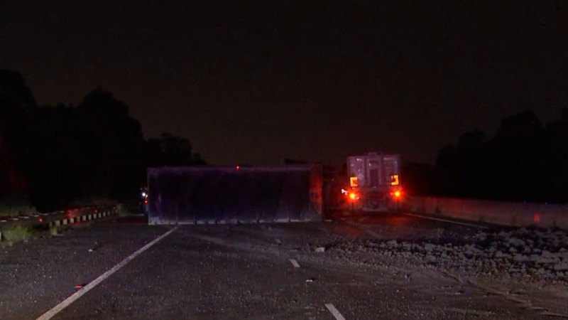 Truck rollover brings busy Melbourne motorway to a standstill