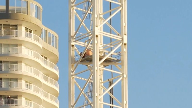 Streets shut down after man climbs crane on Gold Coast