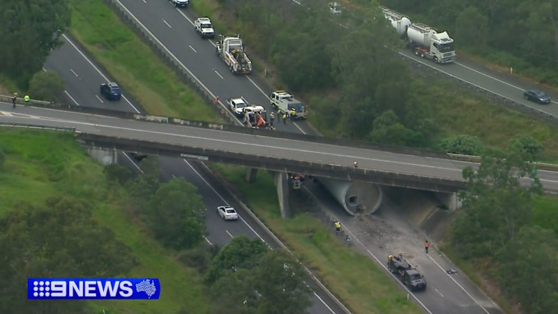 Stuck piece of wind turbine pulled free from overpass