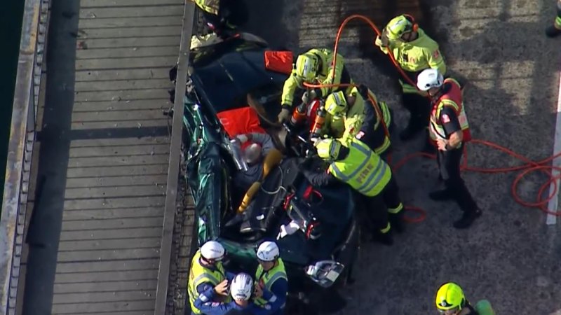 Man freed from crushed car on Sydney bridge