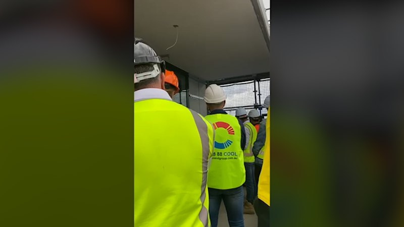 Building Commissioner David Chandler addresses workers