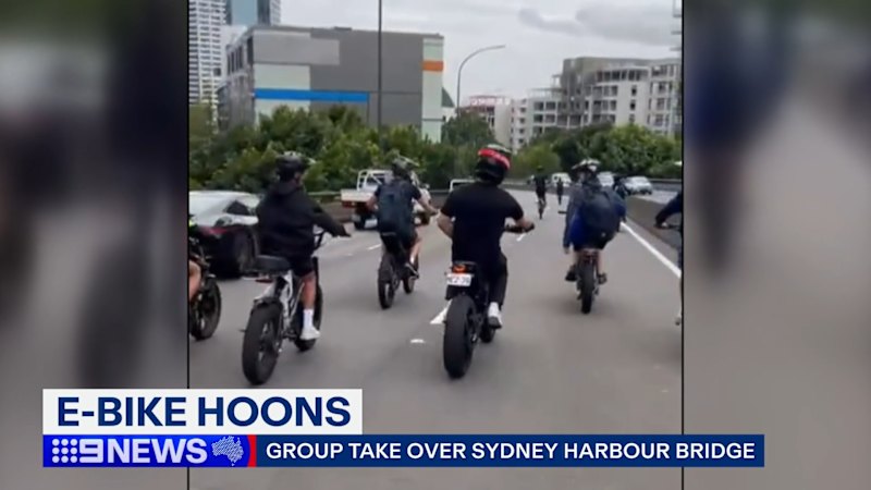 E-bikes swarm Sydney Harbour Bridge in wild footage
