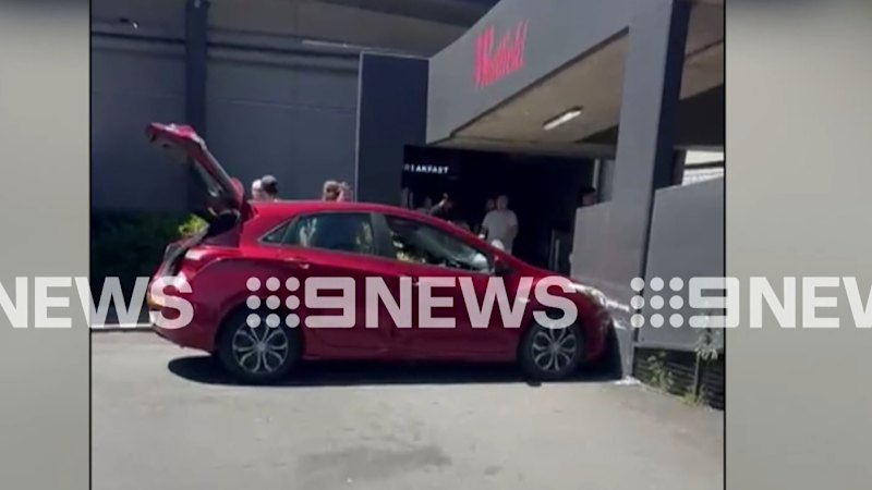 Man, 21, arrested after 'running through shopping centre with knife' in Sydney