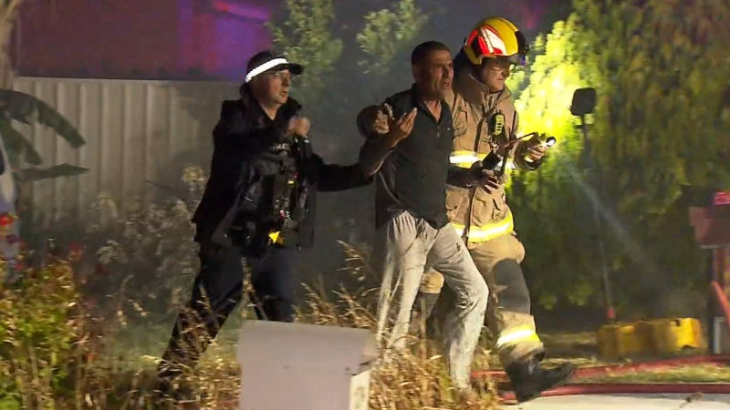 Man rescued from own backyard after fierce house fire erupts