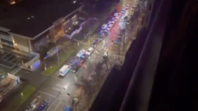 A guard of honour formed when bodies of slain officers were taken to the coroners court