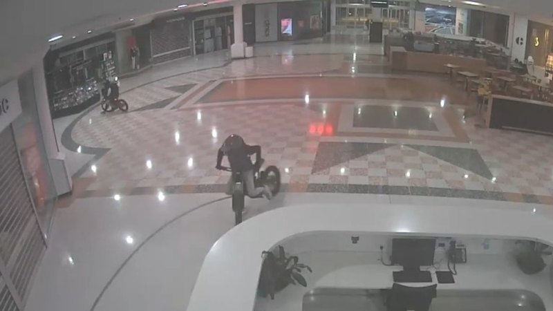 Police hunt two e-bike riders after burnouts inside Canberra shopping centre