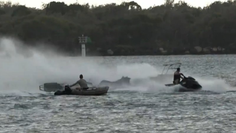 Jet-ski riders spring into action as houseboat catches fire