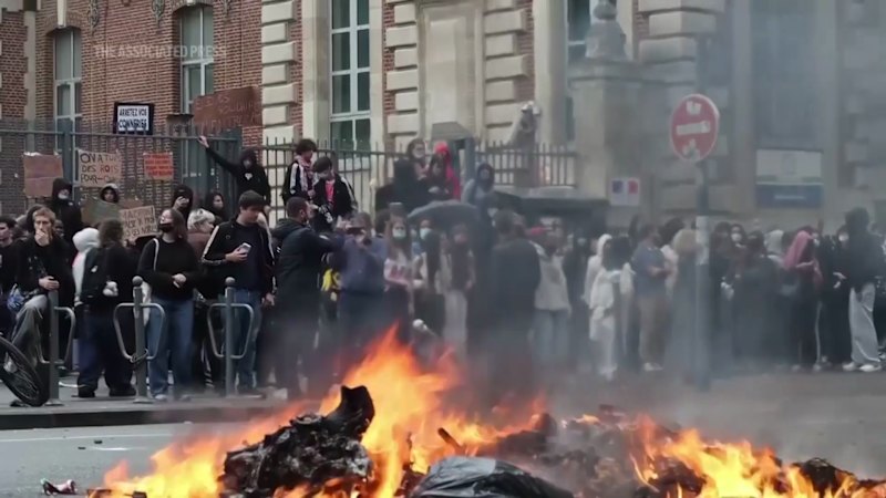 Students in France set trash bins ablaze during protest over school funding