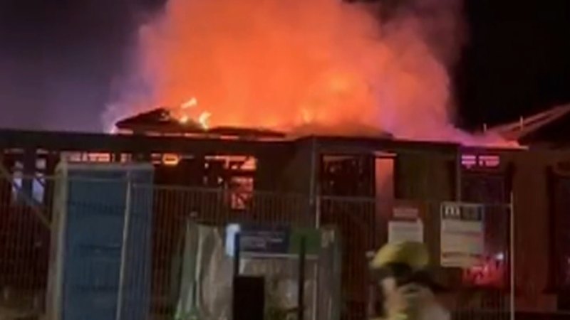 Two men fighting for life, woman in hospital under police guard after house fire