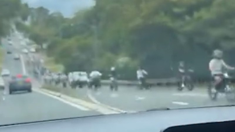 Flood of e-bikes takes over suburban road in wild footage