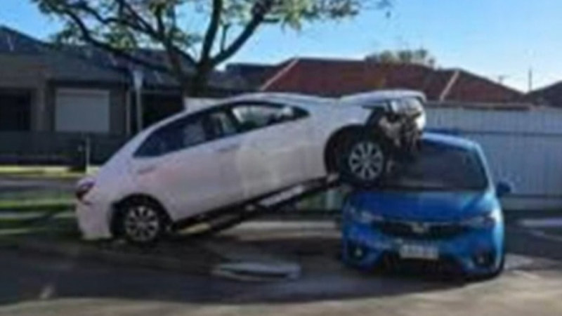 Toyota lands upside down on top of parked car in Adelaide crash