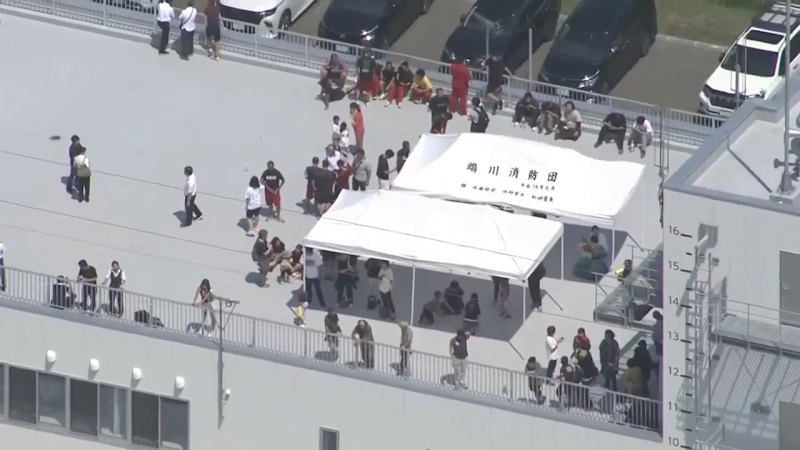 People on top of a building following tsunami alert in Japan