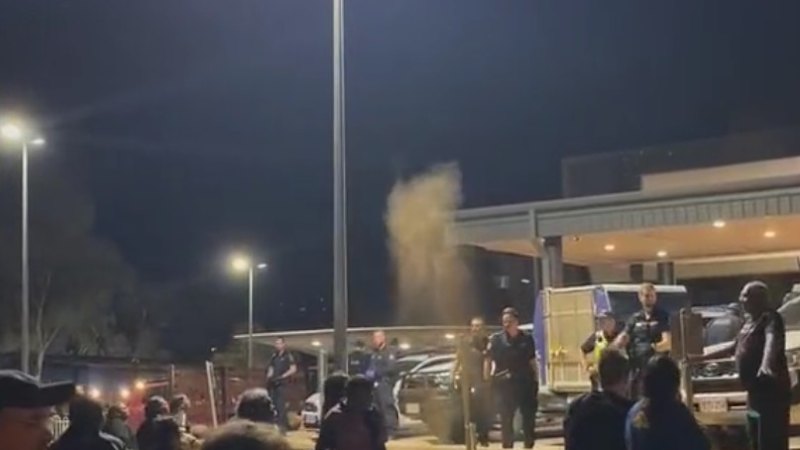 Crowds gather outside the hospital where Jefferson Lewis was taken