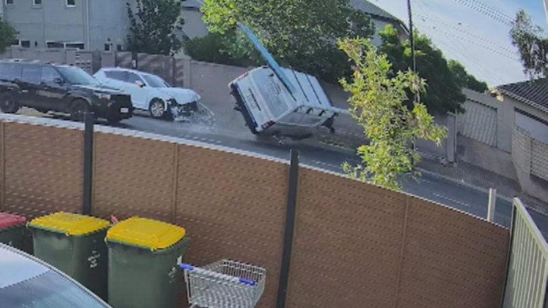 Driver walks from crash after van flips on busy road