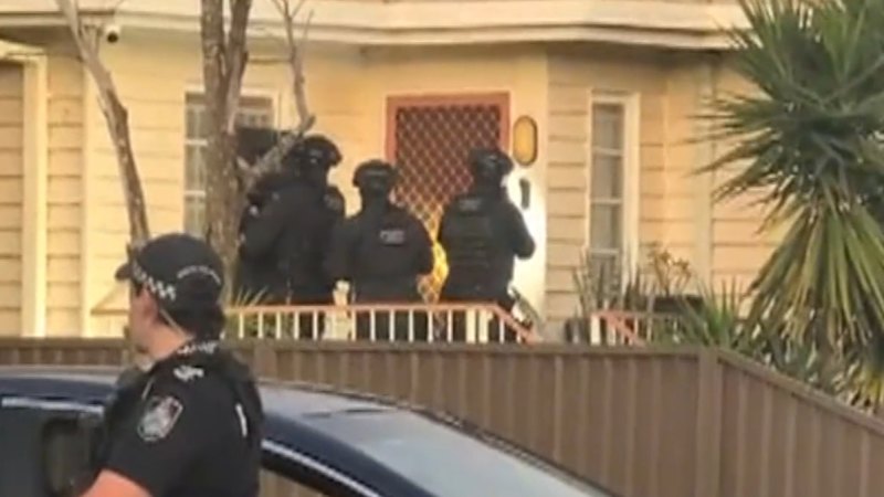 Police swarm Brisbane home