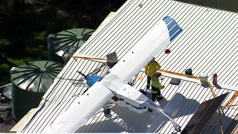 Man injured after light plane crashes on roof of Sydney hangar